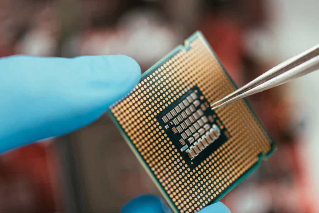 photo-of-a-hand-holding-a-microchip-with-tweezers
