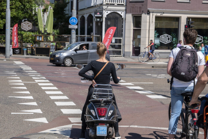 photo-moped-on-bike-path-by-intersection-in-amsterdam