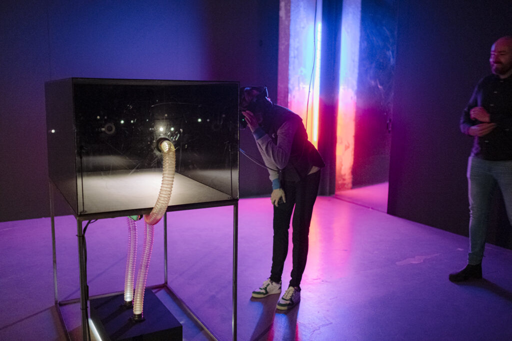 photo-of-mu-hybrid-art-house-exhibition-man-looking-at-exhibit-with-purple-light-in-background