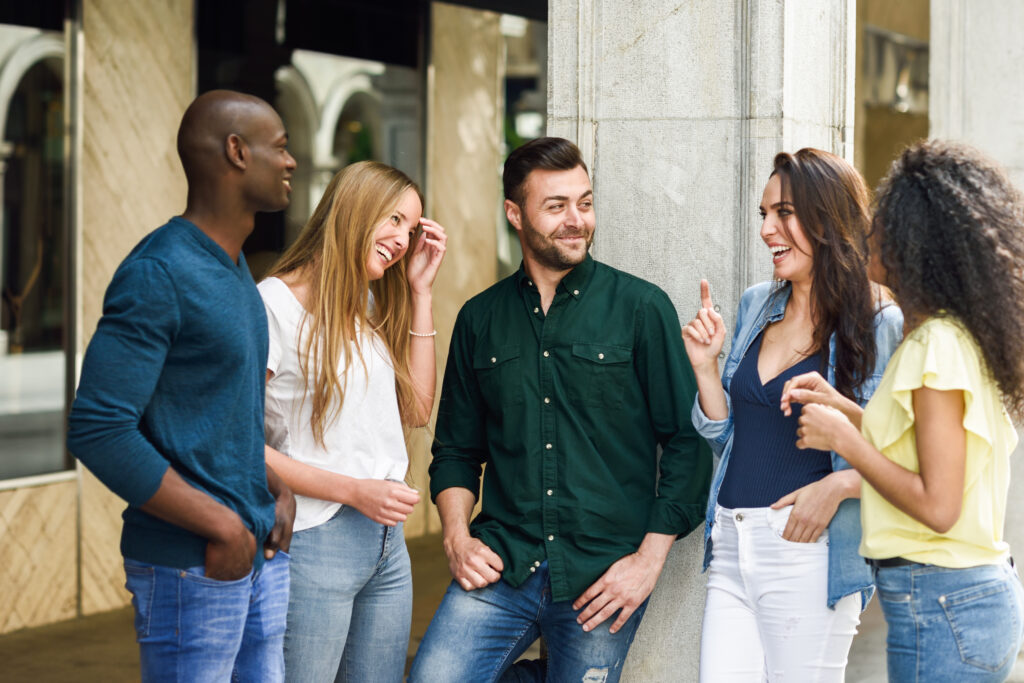 Group-of-friends-women-and-men-hanging-out-together-laughing-and-in-conversation