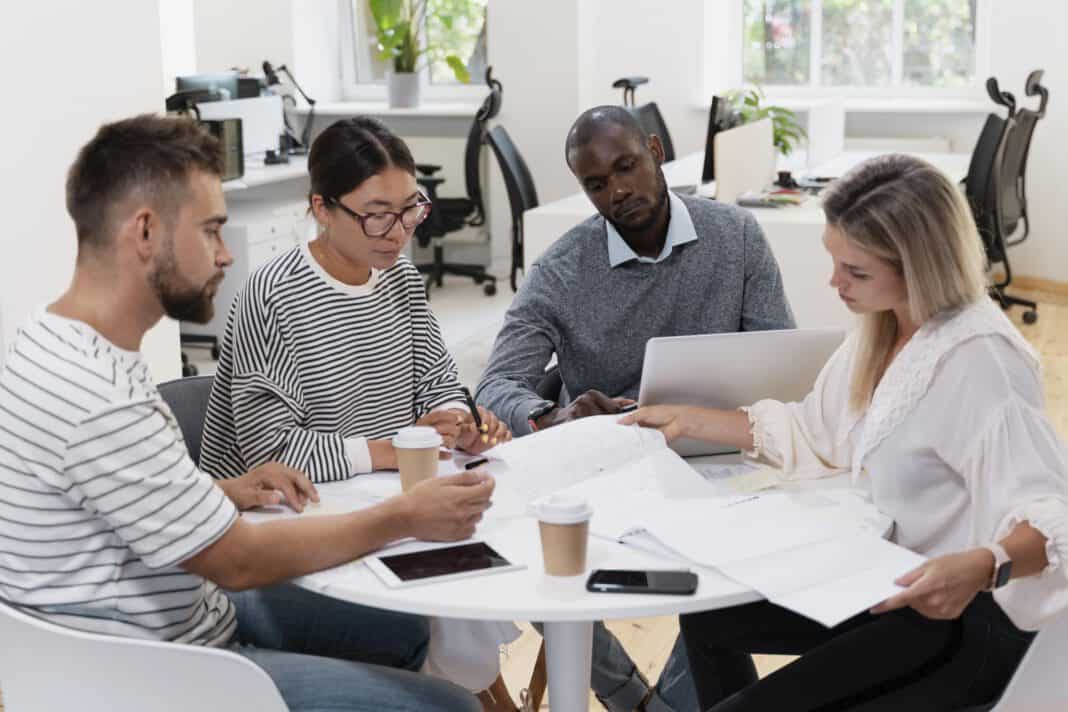 a team of two men and two women from different cultures in a dutch workplace