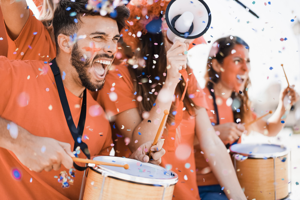 photo-of-orange-sports-fans-netherlands-with-drums