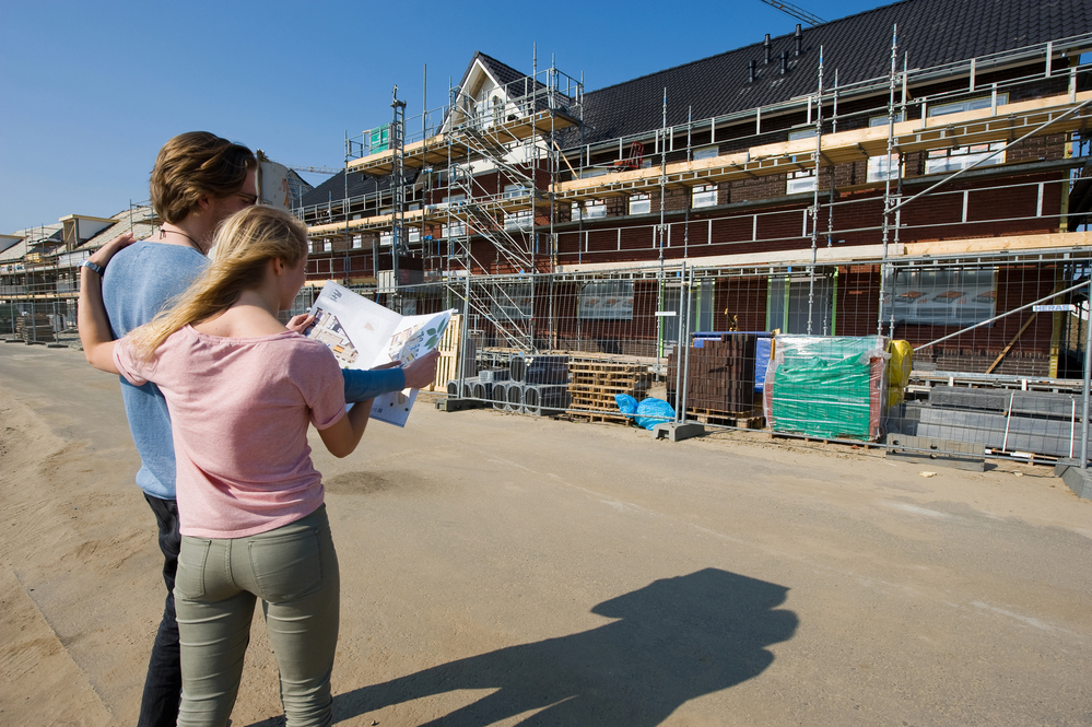 photo-of-couple-standing-at-site-of-new-build-home-Netherlands