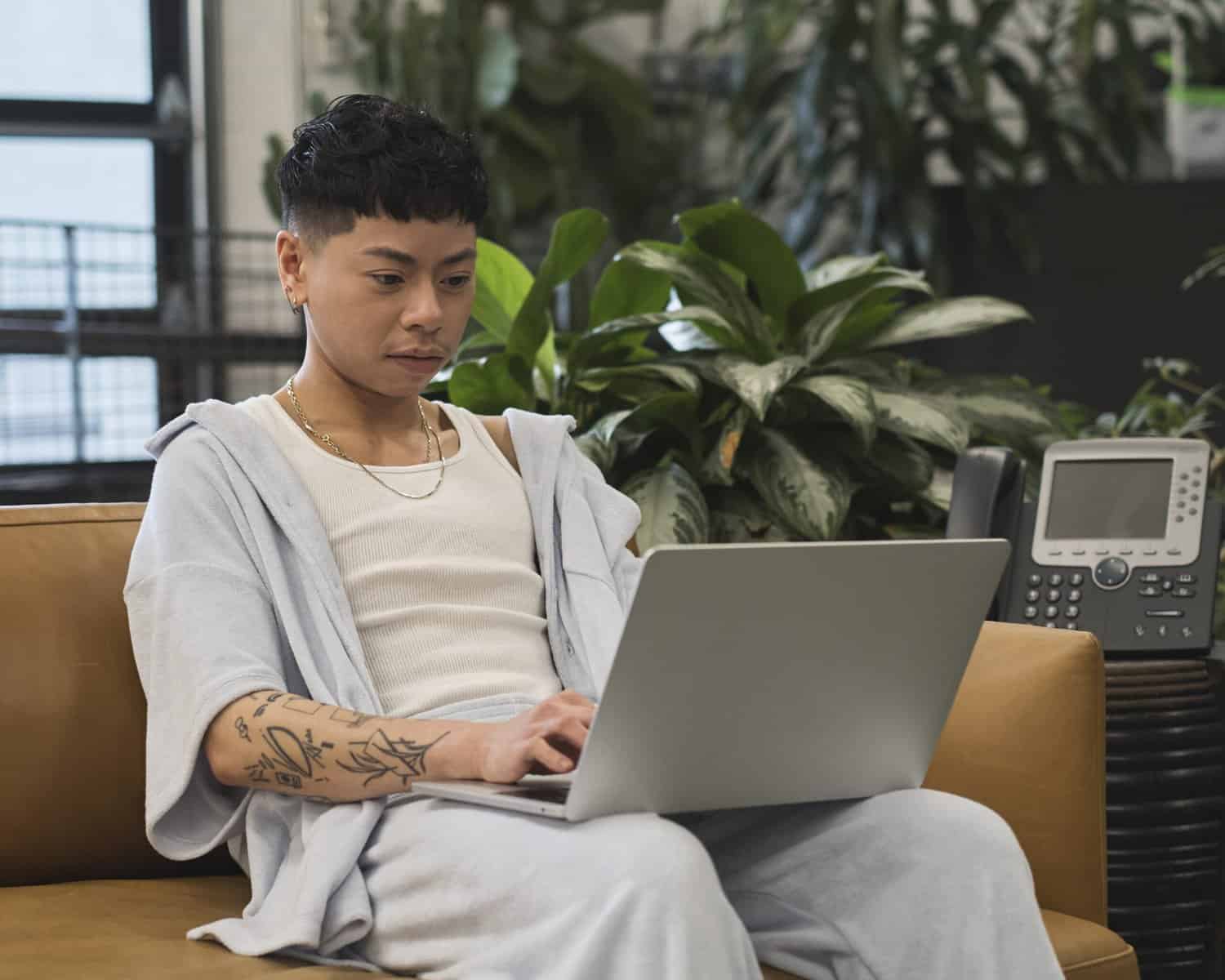 phptp-of-non-binary-person-using-their-laptop-to-research-dutch-gender-care-cropped