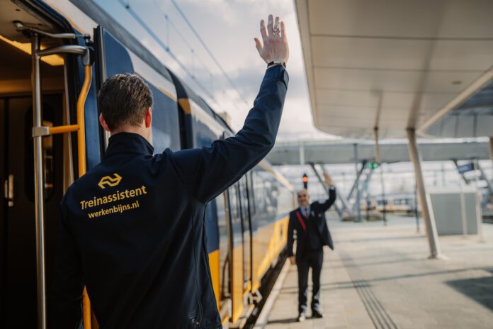 photo-of-train-conductor-waving-to-train-engineer-in-netherlands
