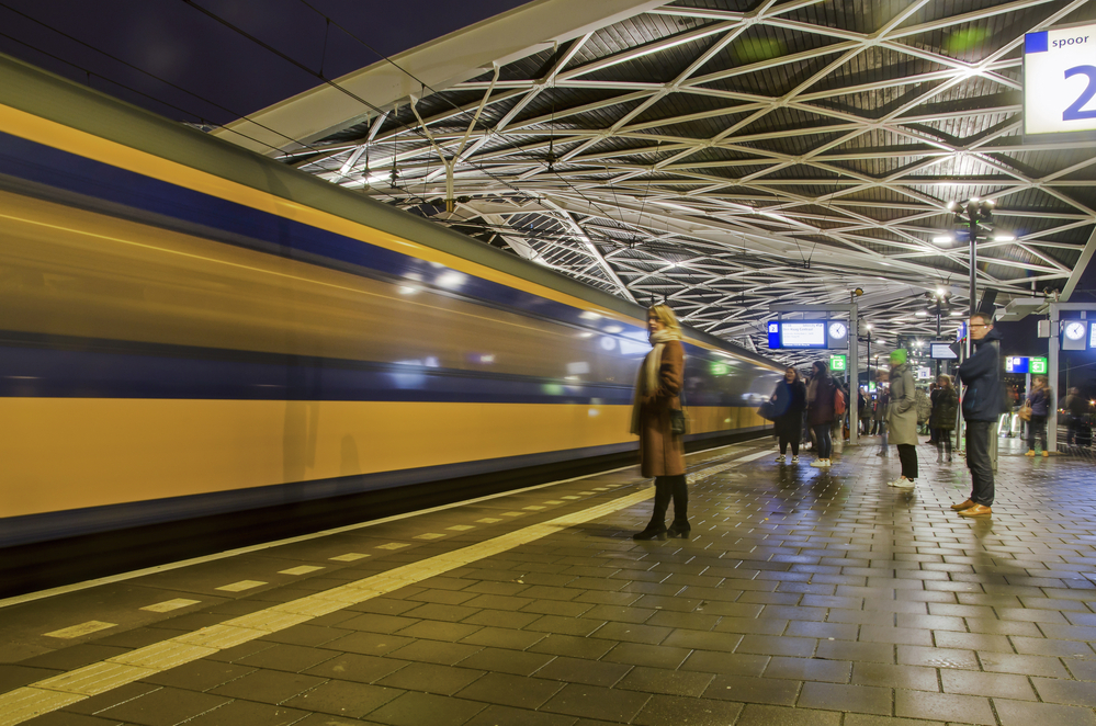 woman-boarding-yellow-and-blue-ns-train-with-cheap-dutch-train-ticket