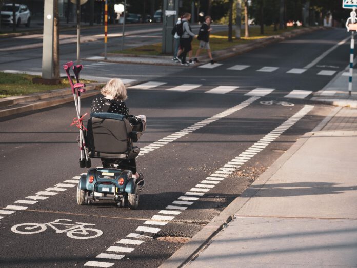old-person-riding-mobility-scooter-on-road-in-netherlands (1)