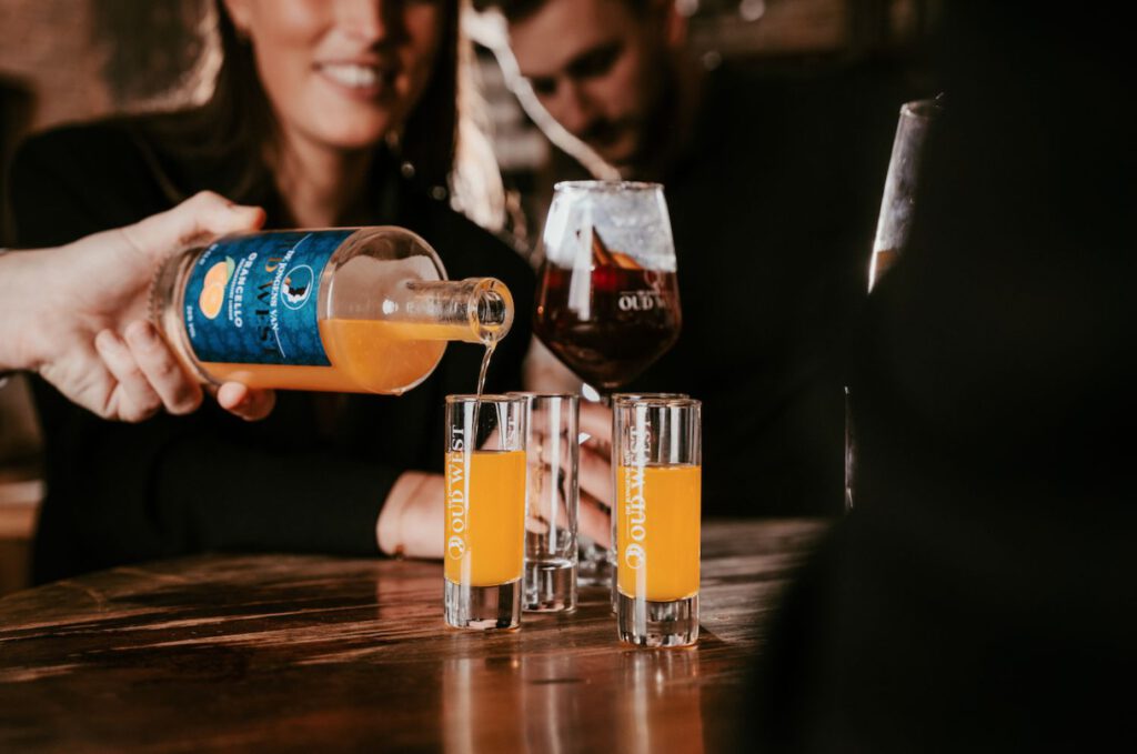 orancello-pouring-drink-into-shot-glass