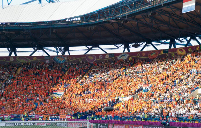 photo-of-dutch-football-fans-wearing-orange-in-crowd-at-match