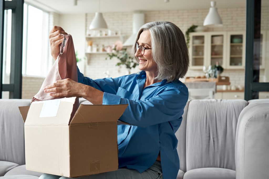 photo-of-woman-smiling-looking-at-parcel-after-ordering-from-webshop-in-the-Netherlands
