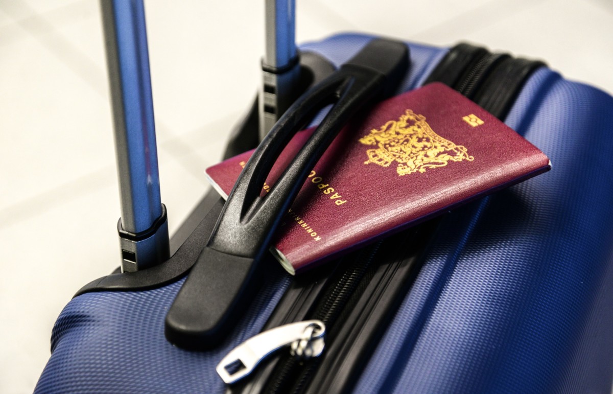 photo-of-passport-on-luggage-in-airport-moving-to-netherlands-for-work-as-nurse