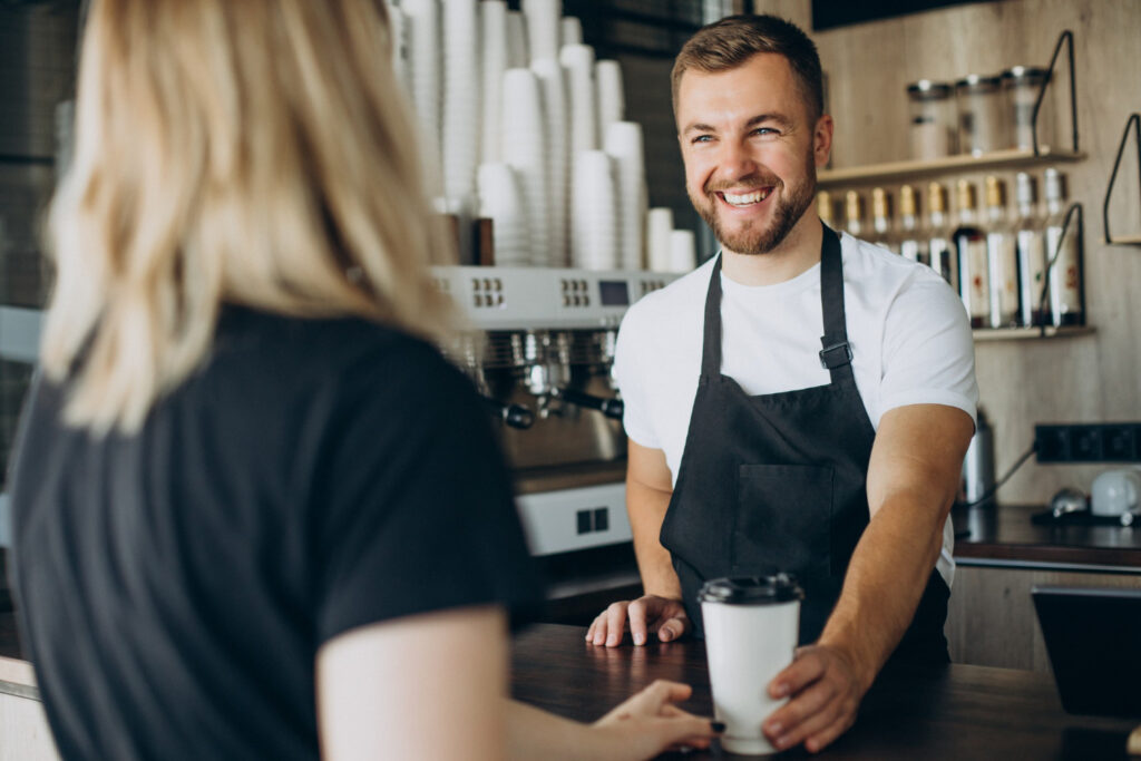 photo-of-barista-with-Dutch-AOW-pension-in-Netherlands-serving-a-customer-at-a-cafe