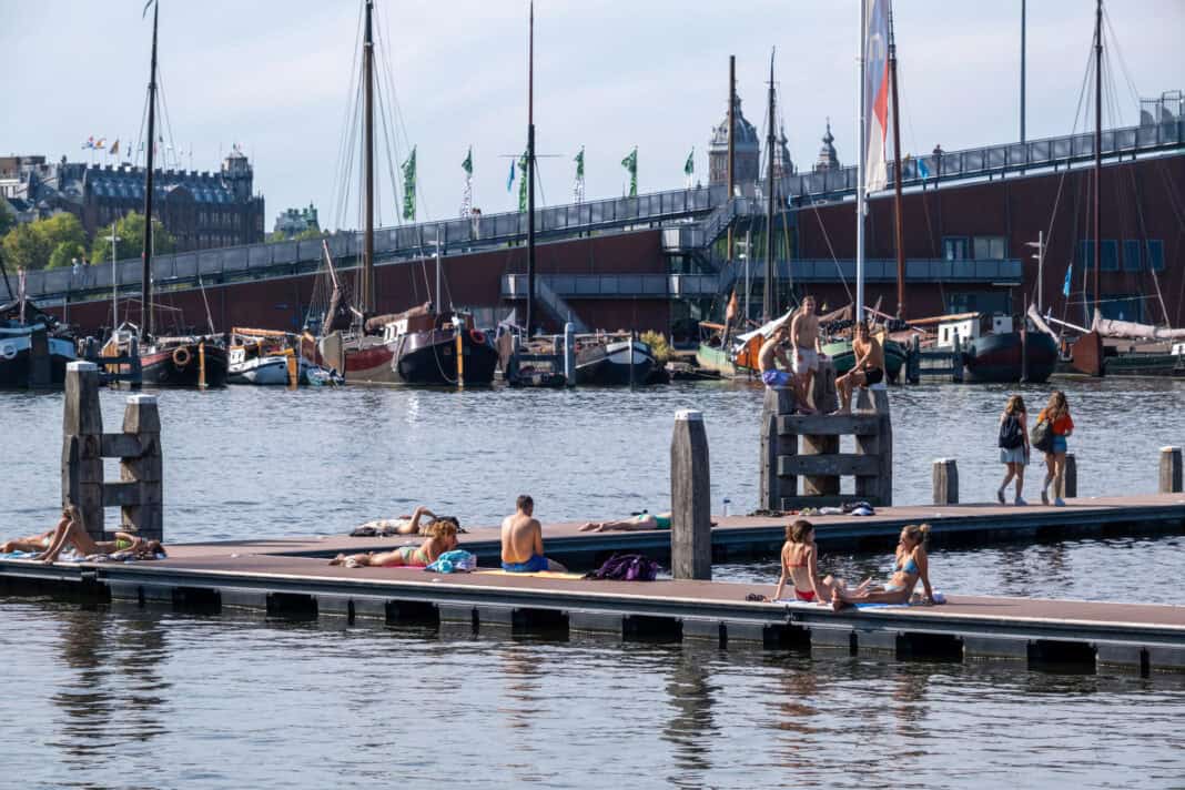 a-photo-of-people-in-Amsterdam-swimming-and-sunbathing-during-heatwave-summer