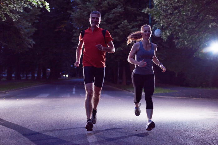 photo-of-couple-jogging-in-dark