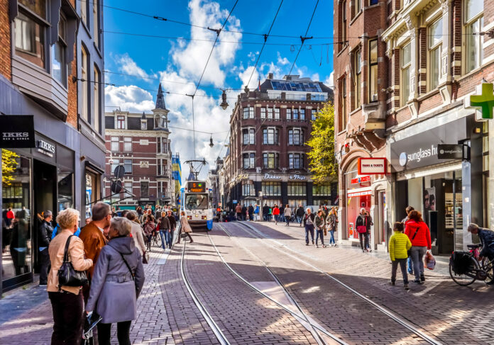 people-walking-shopping-street-amsterdam-sunny-day