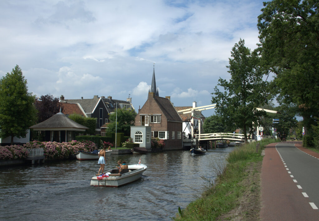 people-riding-boats-in-canals-in-dutch-town-breukelen-utrecht-netherlands