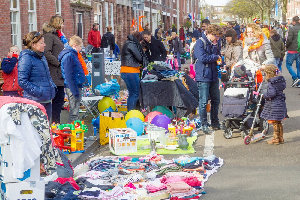 People-selling-things-at-fleamarket-on-Konings-Dag-in-the-Netherlands-outside