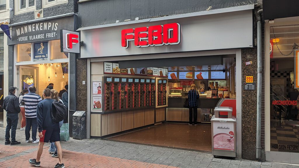 people-walking-past-febo-fast-food-shop-in-the-netherlands