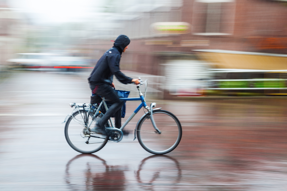 photo-of-man-cycling-biking-in-rain