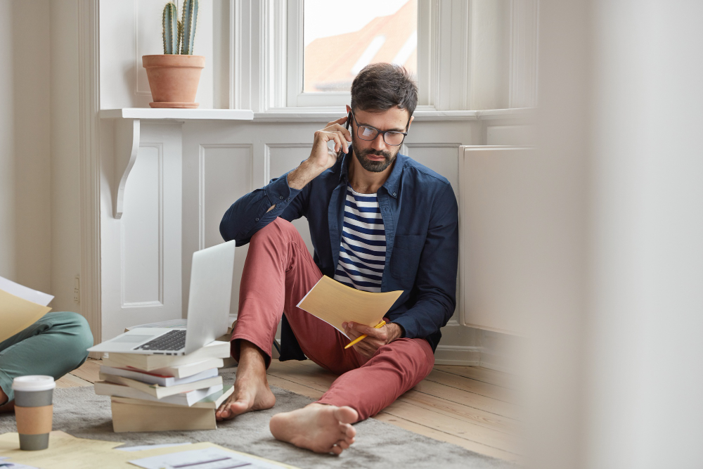 Man-on-the-phone-while-checking-a-document