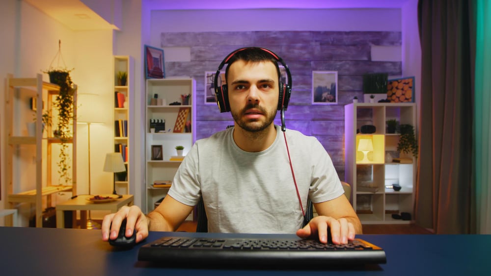 photo-of-man-sitting-at-desk-looking-at-screen-in-front-of-him