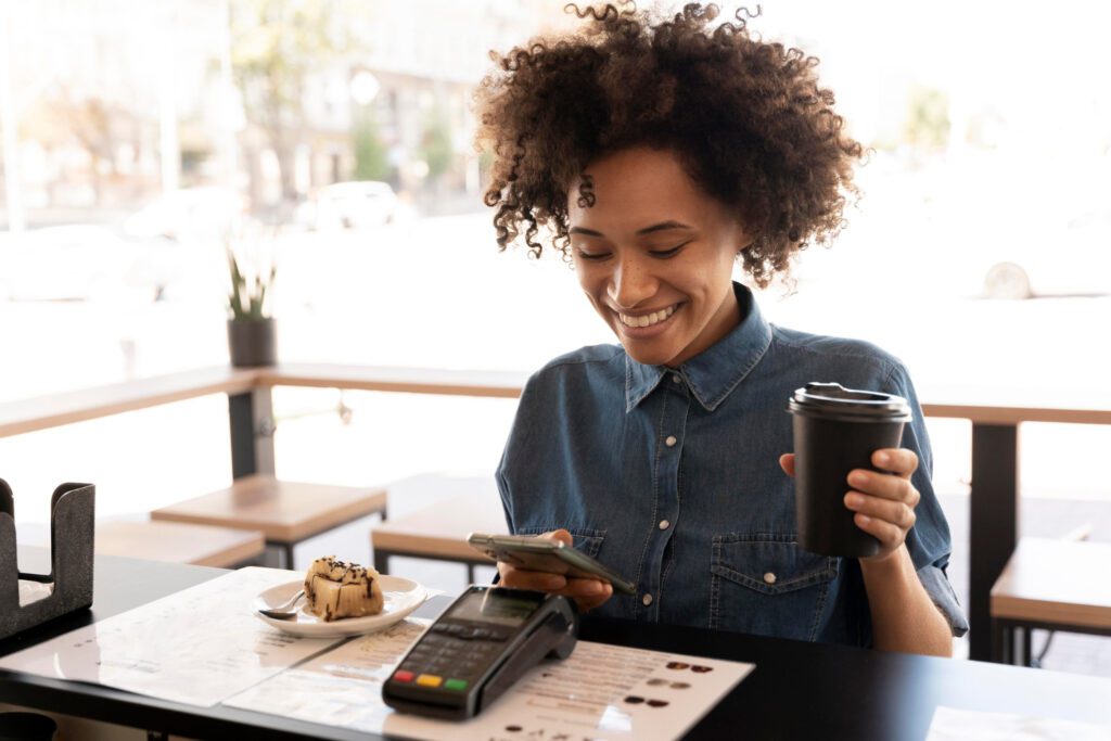 Person-paying-for-coffee-with-mobile-phone