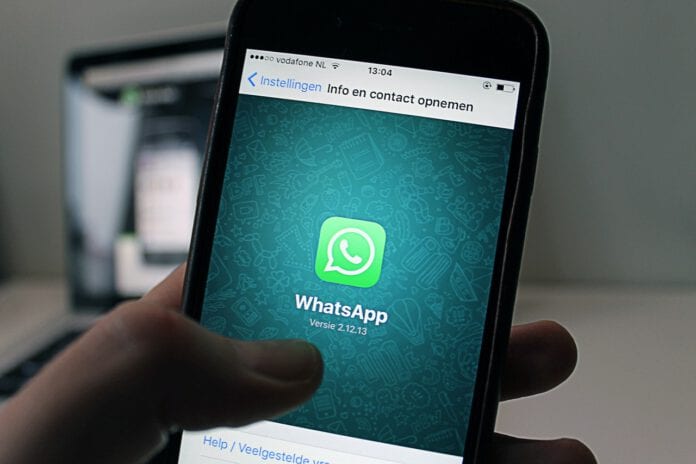 Dutch-person-holding-a-smartphone-checking-Whatsapp