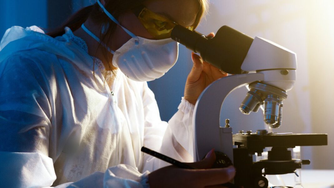 woman-microscope-covid-19-scientist