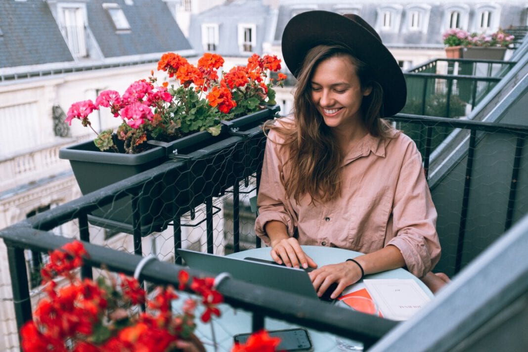 Dutch-woman-wearing-a-hat-working-from-home-outside