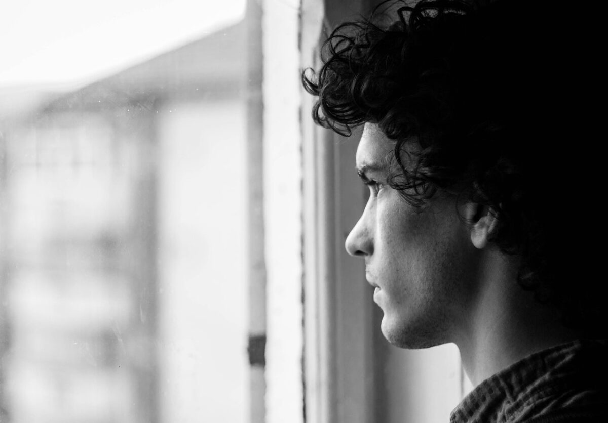 Young-informal-carer-staring-out-window-in-the-Netherlands