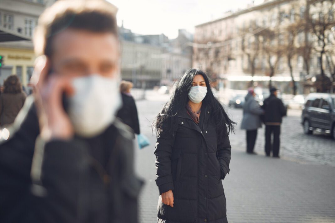 photo-of-two-people-outside-wearing-face-masks