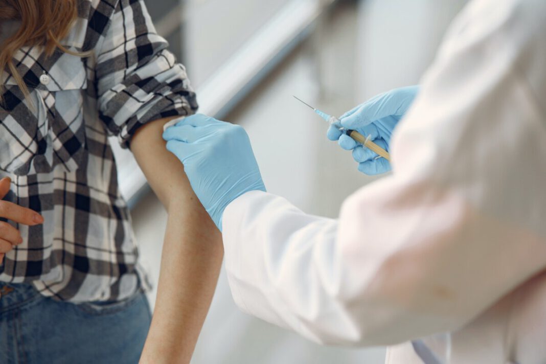 women-in-checked-shirt-getting-the-coronavirus-vaccine-in-the-Netherlands