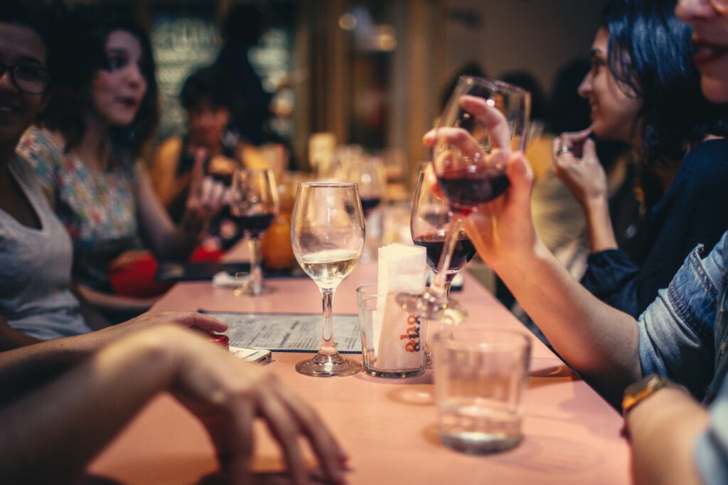 Group-of-people-at-a-dinner-party-sitting-around-a-table-and-talking-after-coming-home-from-the-Netherlands-for-the-holidays