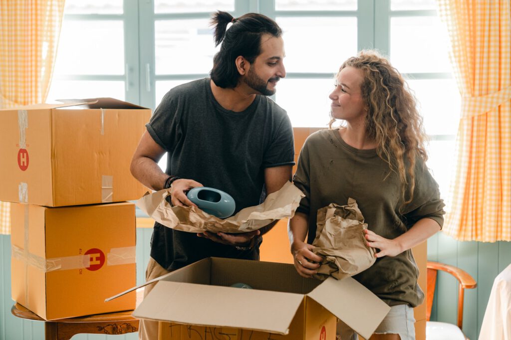 Photo-of-young-couple-unpacking-boxes