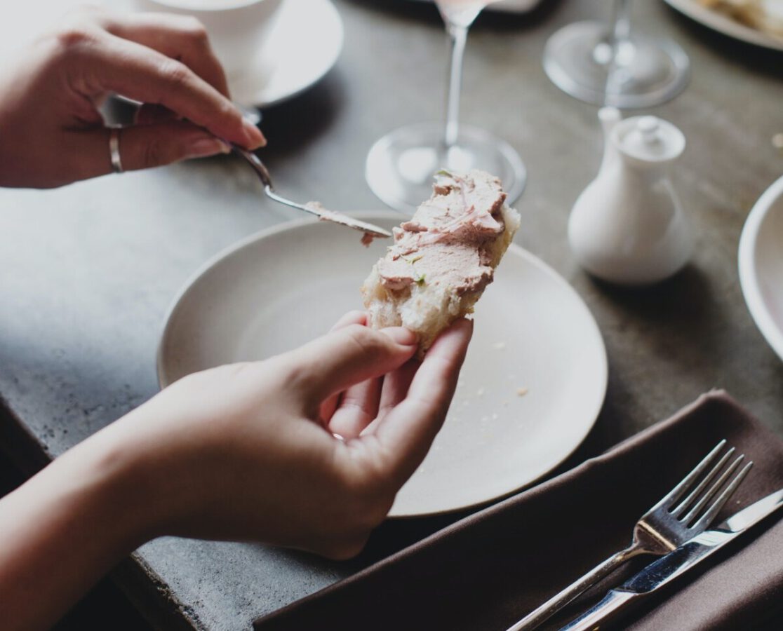 photo-of-a-woman-putting-spread-on-her-bread