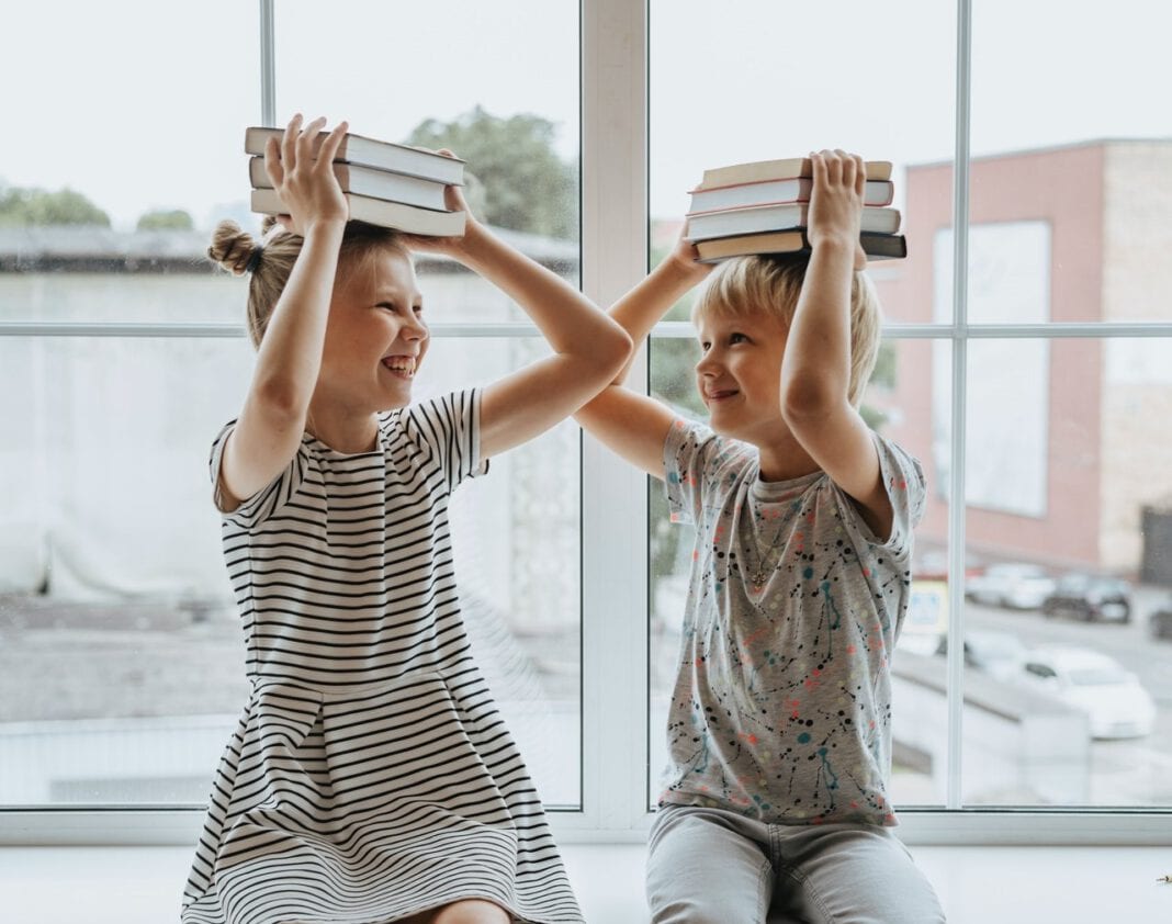 photo-of-a-brother-and-a-sister-with-books