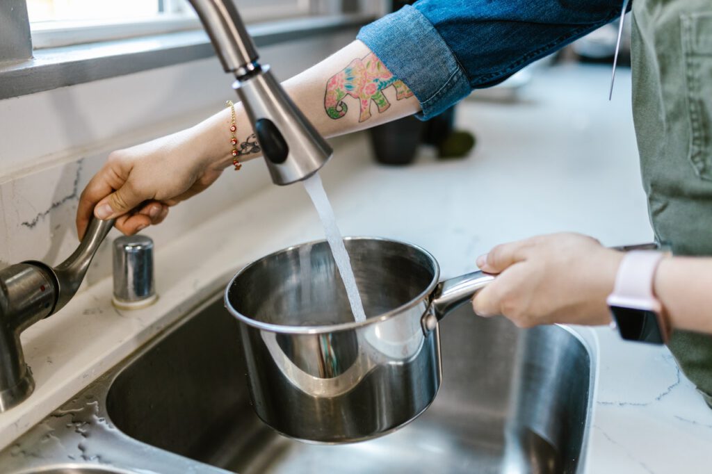Photo-of-person-filling-pot-with-tap-water