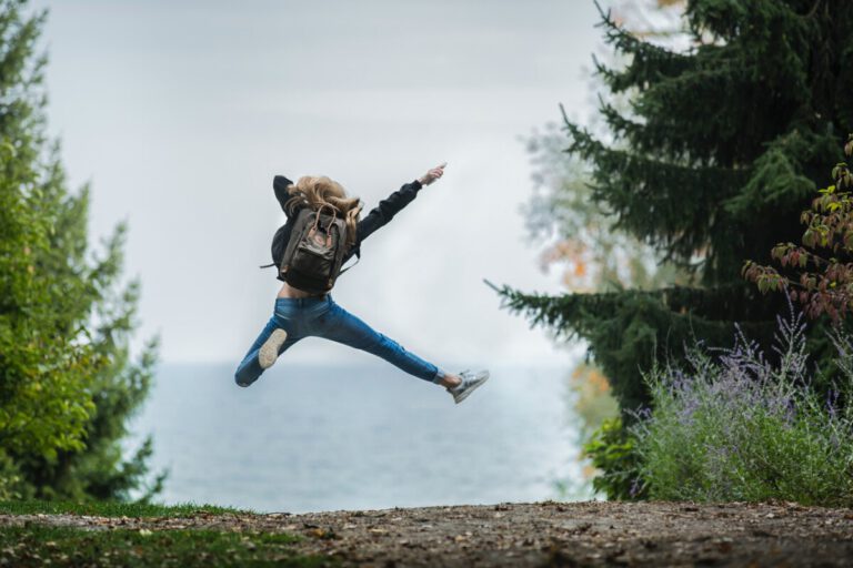 girl-jumping-in-air-in-forest
