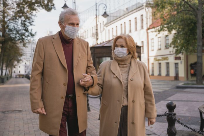 elderly couple wearing masks