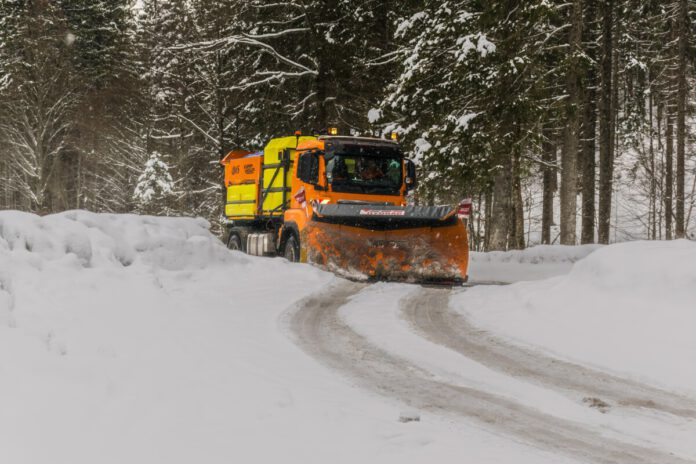 yellow-and-orange-truck-in-snow