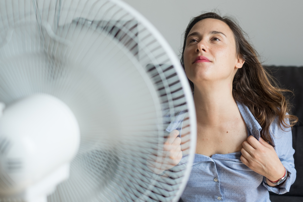 photo-of-woman-in-heatwave-cooling-down-in-front-of-fan