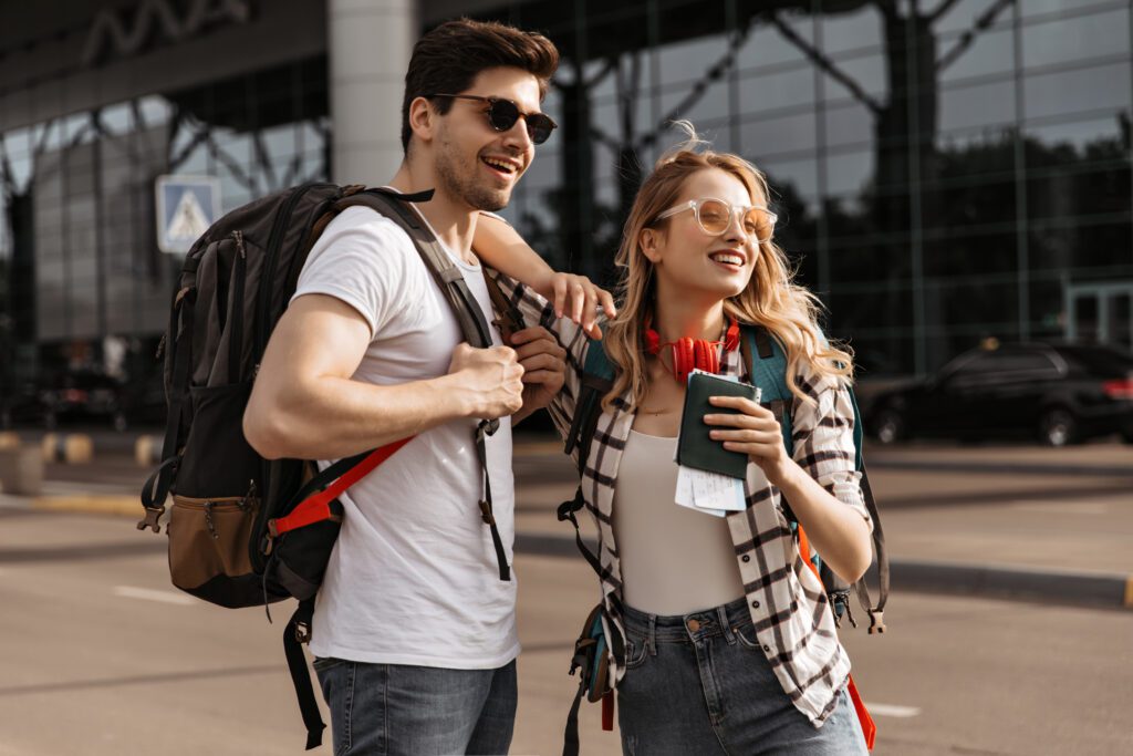 photograph-of-a-couple-wearing-backpacks-and-holding-their-passports