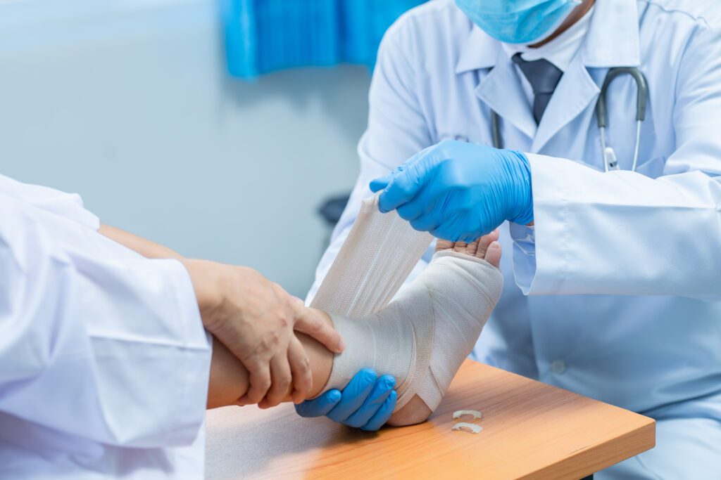 photograph-of-a-doctor-wrapping-the-leg-of-a-patient-with-Dutch-health-insurance-up-in-gauze