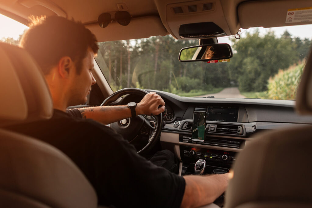 photograph-of-a-man-driving-his-car-through-the-woods-whilst-on-vacation