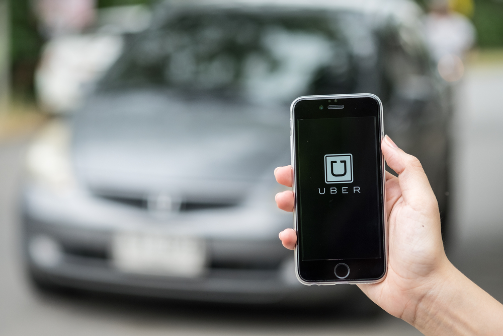 picture-of-person-holding-phone-waiting-for-uber-they-requested