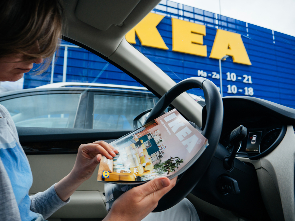 picture-of-person-reading-ikea-magazine-in-car-with-ikea-building-in-background-netherlands