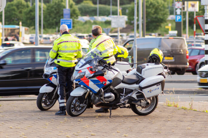 picture-of-two-dutch-police-officers-standing-next-to-bikes-on-road-netherlands