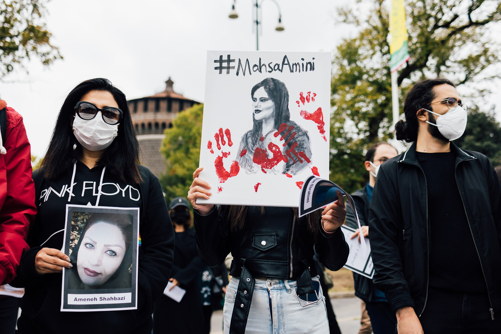 picture-of-women-protesting-holding-up-sign-of-support-for-mahsa-amini-iranian-woman-fight-against-oppression-of-hijabs