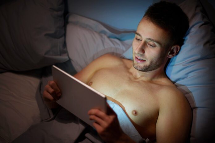 photo-of-man-watching-porn-on-ipad-at-night