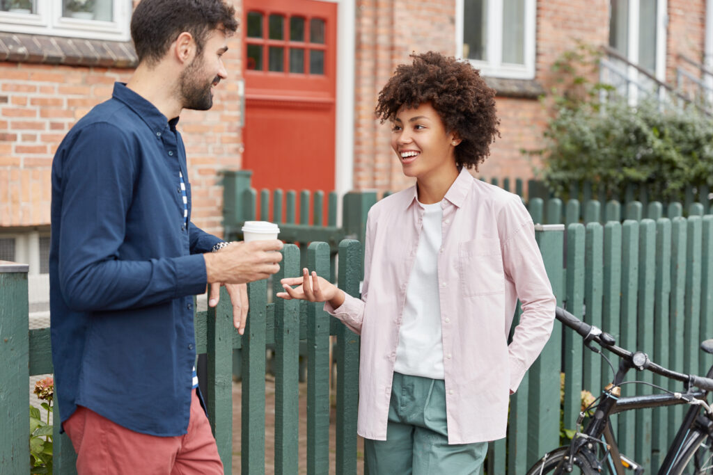 Two-neighbours-talking-with-each-other-outside